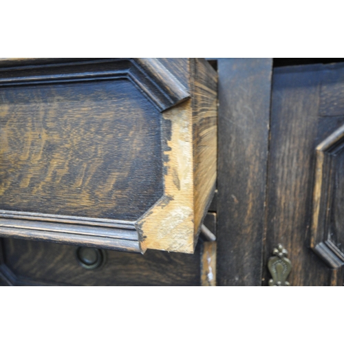 1296 - AN EARLY 20TH CENTURY OAK SIDEBOARD, the raised back with floral carving, geometric panels, on acorn... 