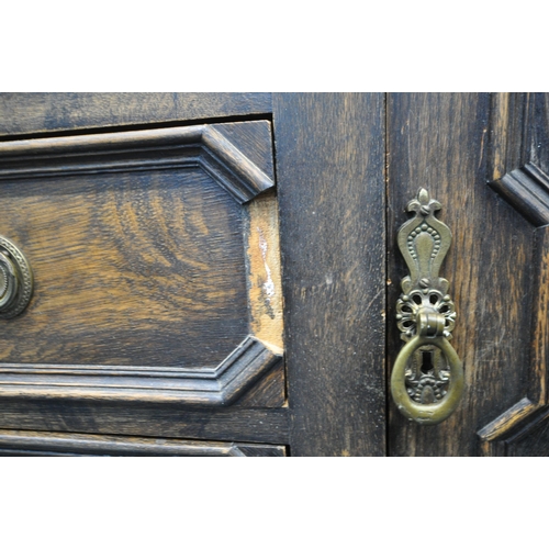 1296 - AN EARLY 20TH CENTURY OAK SIDEBOARD, the raised back with floral carving, geometric panels, on acorn... 