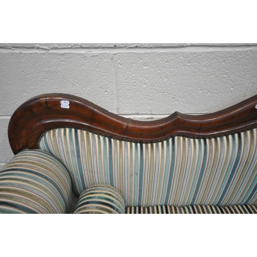 1306 - A VICTORIAN WALNUT THREE SEATER SOFA, with a shaped back, scrolled armrests, on turned legs and late... 