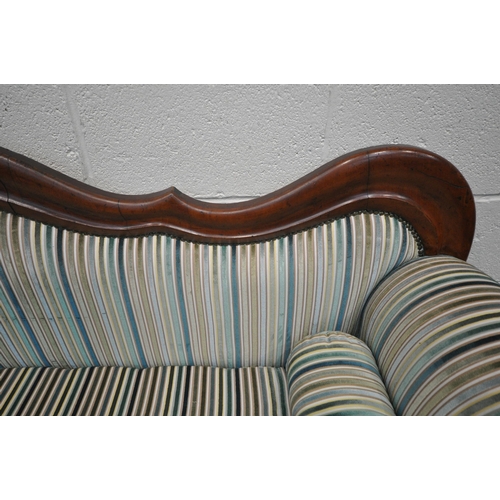 1306 - A VICTORIAN WALNUT THREE SEATER SOFA, with a shaped back, scrolled armrests, on turned legs and late... 