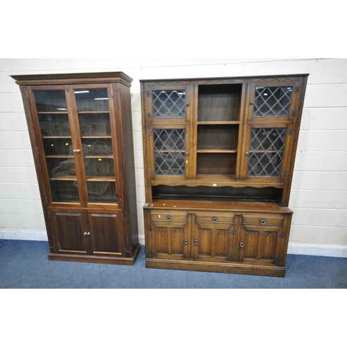 1309 - A 20TH CENTURY OAK BOOKCASE, fitted with four lead glazed doors, flanking a central shelving section... 