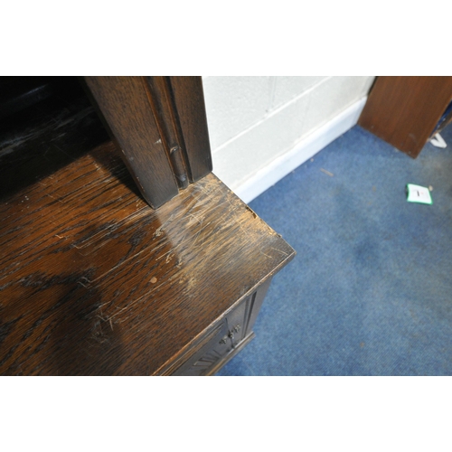 1309 - A 20TH CENTURY OAK BOOKCASE, fitted with four lead glazed doors, flanking a central shelving section... 