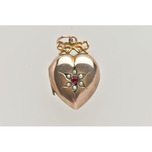 10 - A YELLOW METAL HEART SHAPE LOCKET PENDANT, polished heart with ruby and split pearl detail, stamped ... 