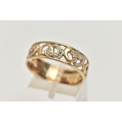 3 - A 9CT GOLD BAND RING, open work wide band, detailed with hearts set with single cut diamond accents,... 