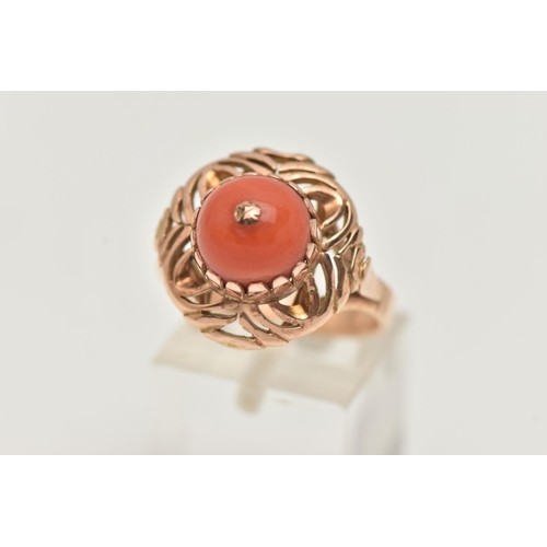 4 - A YELLOW METAL CORAL RING, set with a raised coral cabochon with pin to the centre, in a claw settin... 