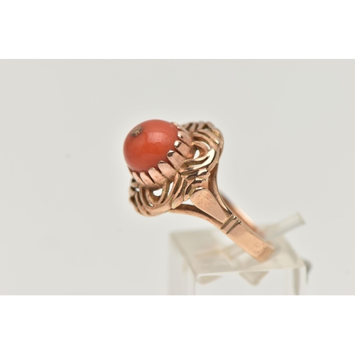 4 - A YELLOW METAL CORAL RING, set with a raised coral cabochon with pin to the centre, in a claw settin... 