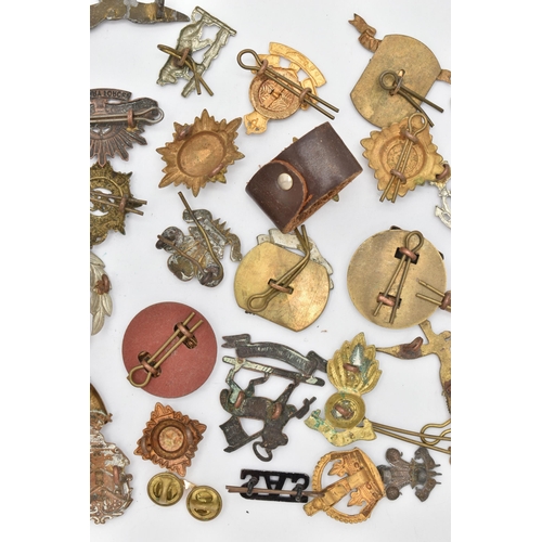 103 - AN ASSORTMENT OF CAP BADGES, a selection of cap badges and pins from various military regiments