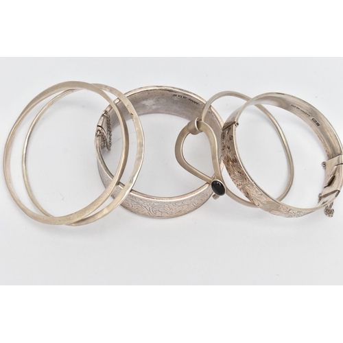 109 - THREE SILVER BANGLES AND TWO WHITE METAL BANGLES, the first a silver wide hinged bangle, with scroll... 