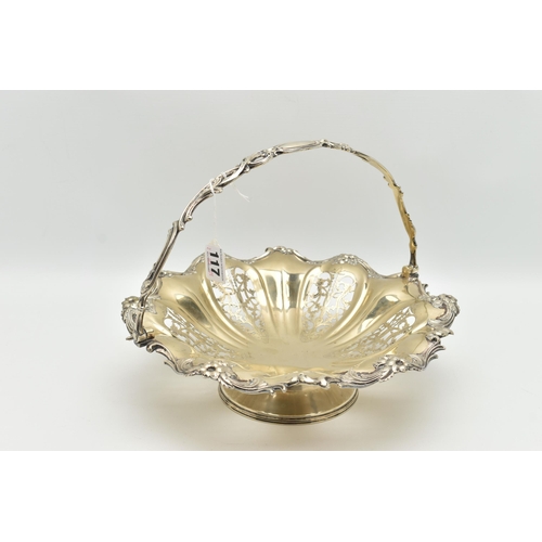 117 - A WHITE METAL CAKE BASKET DISH, the dish with openwork foliate detail within a floral and scrolling ... 