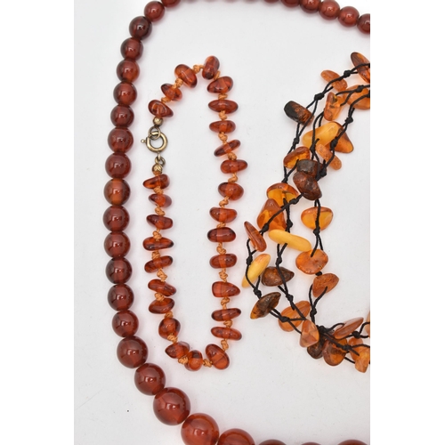 83 - AMBER BEAD NECKLACES AND PLASTIC BEAD NECKLACES, to include an amber bead necklace knotted on a blac... 