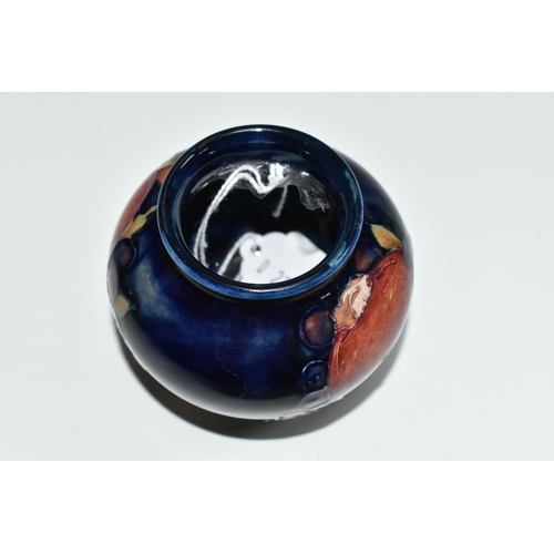 304 - A MOORCROFT POTTERY POMEGRANATE VASE, of squat form, tube lined in Pomegranate pattern on a deep blu... 