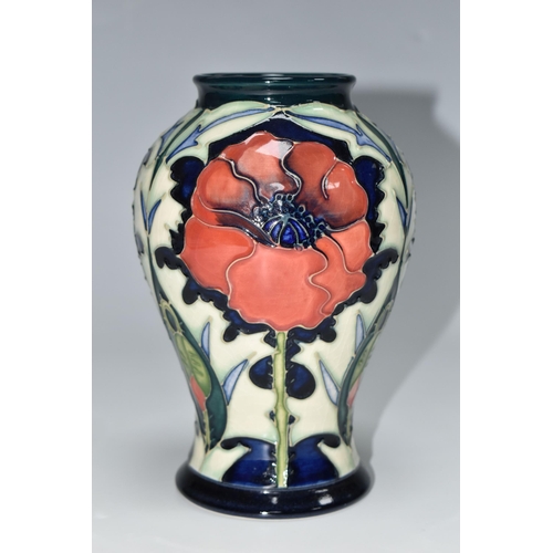 306 - A MOORCROFT POTTERY BALUSTER VASE DECORATED WITH POPPIES ON A PALE GREEN AND DARK BLUE GROUND, circa... 