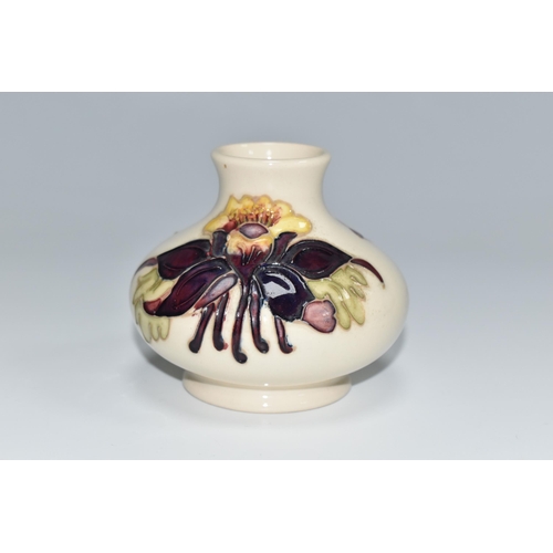 307 - A MOORCROFT POTTERY SQUAT COLUMBINE VASE, tube lined with purple, red and yellow columbine flowers o... 