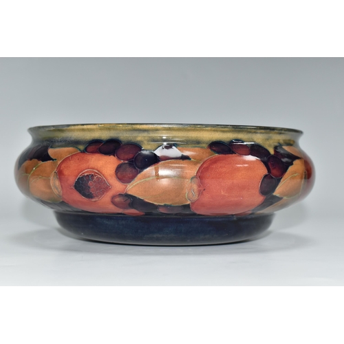 322 - A MOORCROFT POTTERY POMEGRANATE BOWL, decorated with pomegranates on a mottled blue ground, impresse... 