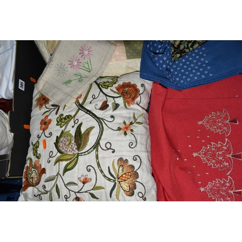 385 - TWO BOXES OF TABLE LINEN AND CUSHIONS, to include two hand embroidered cushions, a patchwork cushion... 