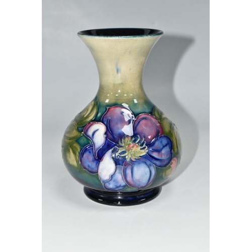 419 - A MOORCROFT POTTERY CLEMATIS VASE, the flared necked vase in 'Clematis' pattern on a graduated green... 