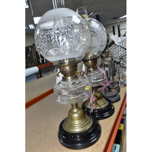 428 - A GROUP OF TABLE LAMPS, comprising two Victorian oil lamps with clear glass reservoirs, a pair of br... 