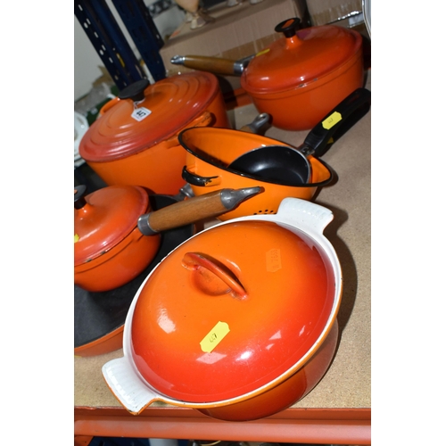 447 - A SMALL GROUP OF ORANGE CAST IRON COOKWARES ETC, comprising a Le Creuset 24cm casserole dish, two un... 