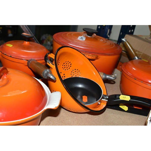 447 - A SMALL GROUP OF ORANGE CAST IRON COOKWARES ETC, comprising a Le Creuset 24cm casserole dish, two un... 