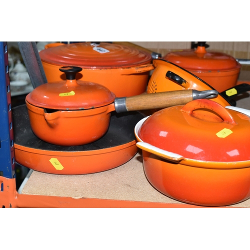 447 - A SMALL GROUP OF ORANGE CAST IRON COOKWARES ETC, comprising a Le Creuset 24cm casserole dish, two un... 