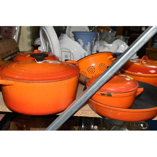 447 - A SMALL GROUP OF ORANGE CAST IRON COOKWARES ETC, comprising a Le Creuset 24cm casserole dish, two un... 