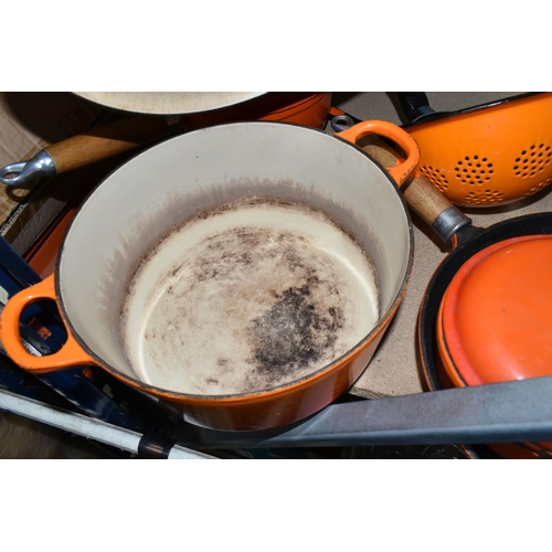 447 - A SMALL GROUP OF ORANGE CAST IRON COOKWARES ETC, comprising a Le Creuset 24cm casserole dish, two un... 