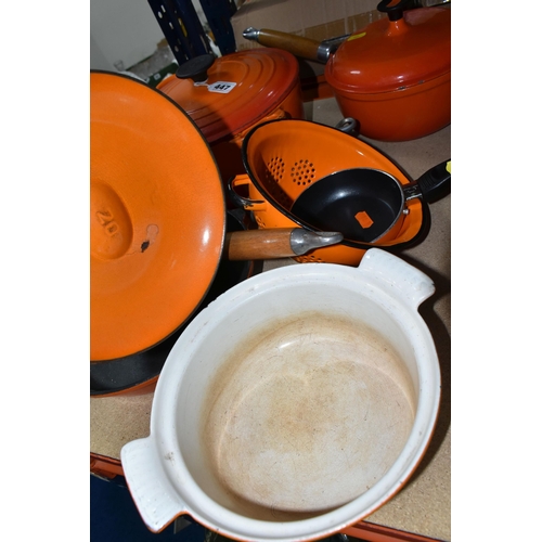 447 - A SMALL GROUP OF ORANGE CAST IRON COOKWARES ETC, comprising a Le Creuset 24cm casserole dish, two un... 