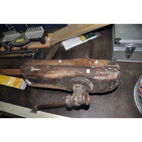 1100 - A VINTAGE OAK LEG VICE, an aluminium case, a mitre saw, various grinding discs, etc