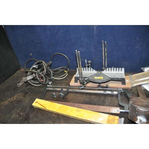 1100 - A VINTAGE OAK LEG VICE, an aluminium case, a mitre saw, various grinding discs, etc