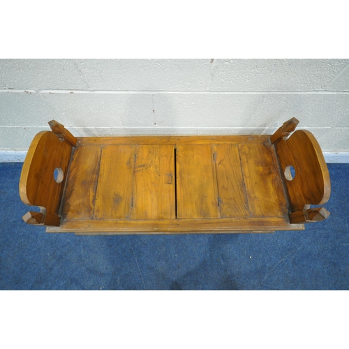 1202 - A 20TH CENTURY HARDWOOD BENCH, the twin arched ends with finials, a double hinged storage compartmen... 