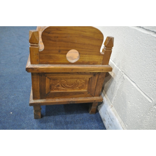 1202 - A 20TH CENTURY HARDWOOD BENCH, the twin arched ends with finials, a double hinged storage compartmen... 