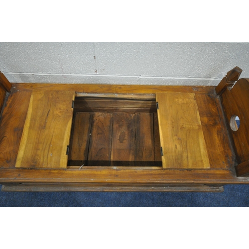 1202 - A 20TH CENTURY HARDWOOD BENCH, the twin arched ends with finials, a double hinged storage compartmen... 