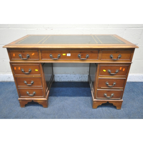 1203 - A 20TH CENTURY YEWWOOD TWIN PEDESTAL DESK, with a green tooled leather writing surface, fitted with ... 