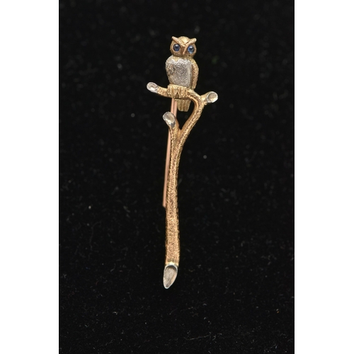 11 - AN OWL BROOCH, designed as an owl with sapphire cabochon eyes perched atop a branch, unmarked, appro... 