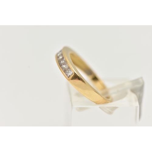 7 - AN 18CT GOLD SEVEN STONE DIAMOND RING, designed as seven princess cut diamonds in a channel setting,... 