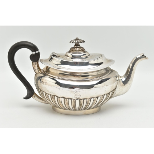 100 - AN EDWARDIAN SILVER TEAPOT, oval form with a polished and stop reeded pattern, engraved crest dated ... 