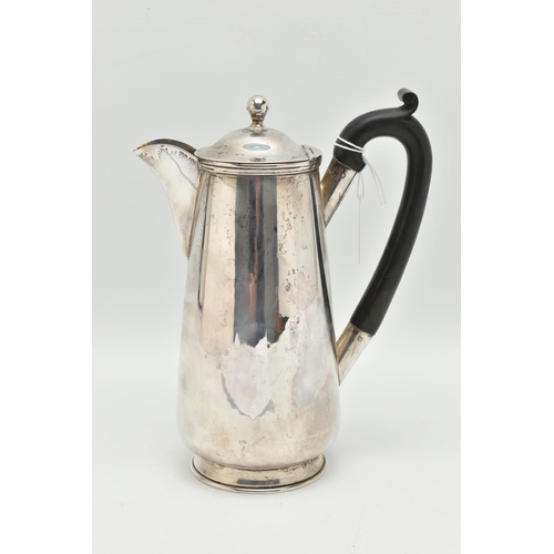 101 - A GEORGE V SILVER WATER JUG, polished form, fitted with an ebonised handle, hinged cover fitted with... 