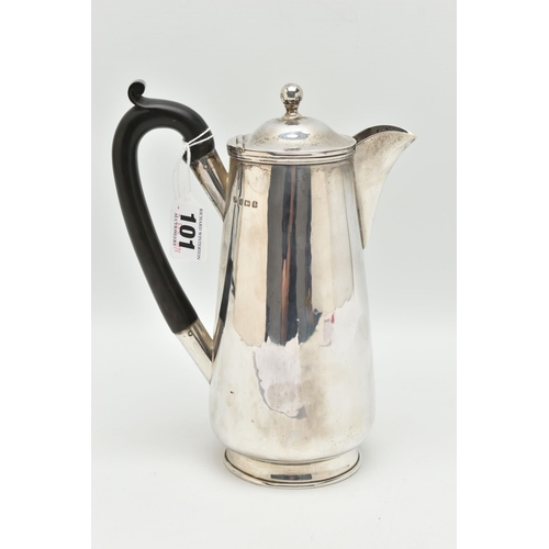 101 - A GEORGE V SILVER WATER JUG, polished form, fitted with an ebonised handle, hinged cover fitted with... 