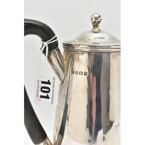 101 - A GEORGE V SILVER WATER JUG, polished form, fitted with an ebonised handle, hinged cover fitted with... 