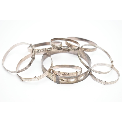 84 - A SELECTION OF MAINLY CHILD'S SILVER AND WHITE METAL BANGLES, to include eight expandable child's ba... 