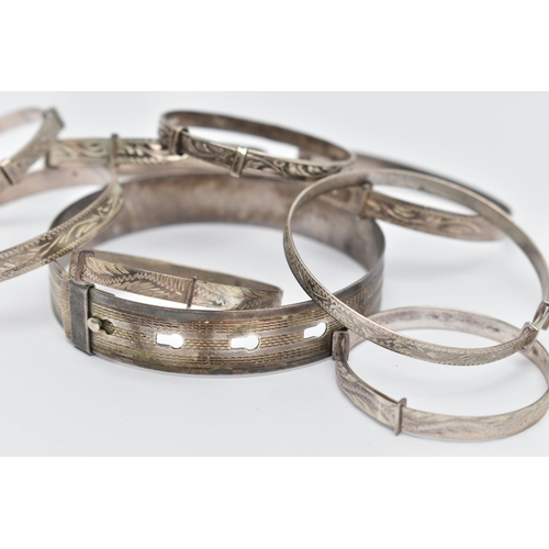 84 - A SELECTION OF MAINLY CHILD'S SILVER AND WHITE METAL BANGLES, to include eight expandable child's ba... 