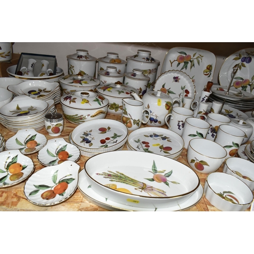 323 - A LARGE QUANTITY OF ROYAL WORCESTER 'EVESHAM' PATTERN DINNERWARE, comprising a 'Pot Du Creme' (handl... 