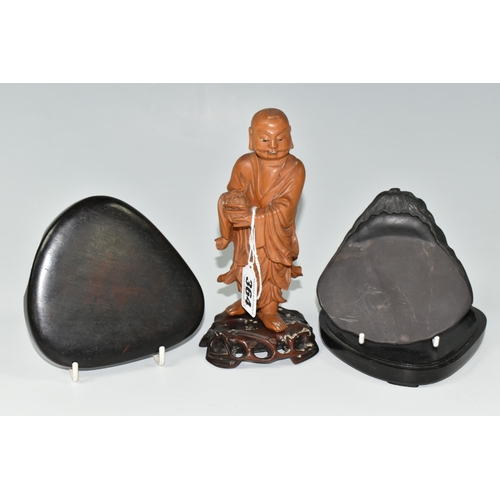 364 - AN ORIENTAL CARVED WOOD FIGURINE, a boxwood carved figure of a smiling Chinese monk bearing a basket... 