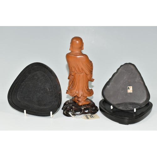 364 - AN ORIENTAL CARVED WOOD FIGURINE, a boxwood carved figure of a smiling Chinese monk bearing a basket... 