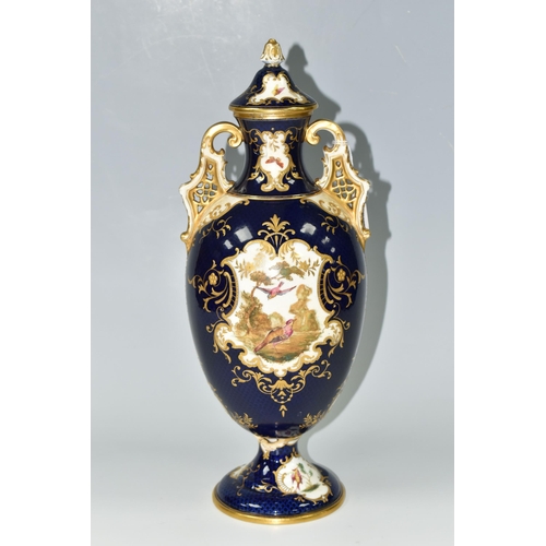 367 - A COALPORT COVERED PEDESTAL VASE, with pierced twin handles, a cobalt blue patterned ground with rai... 