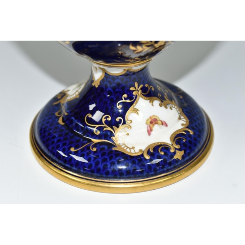 367 - A COALPORT COVERED PEDESTAL VASE, with pierced twin handles, a cobalt blue patterned ground with rai... 