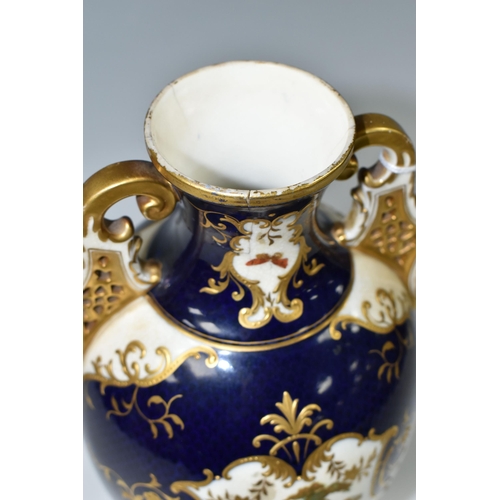 367 - A COALPORT COVERED PEDESTAL VASE, with pierced twin handles, a cobalt blue patterned ground with rai... 