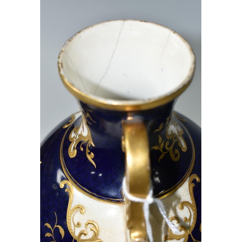 367 - A COALPORT COVERED PEDESTAL VASE, with pierced twin handles, a cobalt blue patterned ground with rai... 