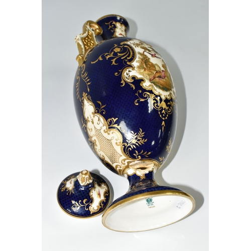 367 - A COALPORT COVERED PEDESTAL VASE, with pierced twin handles, a cobalt blue patterned ground with rai... 