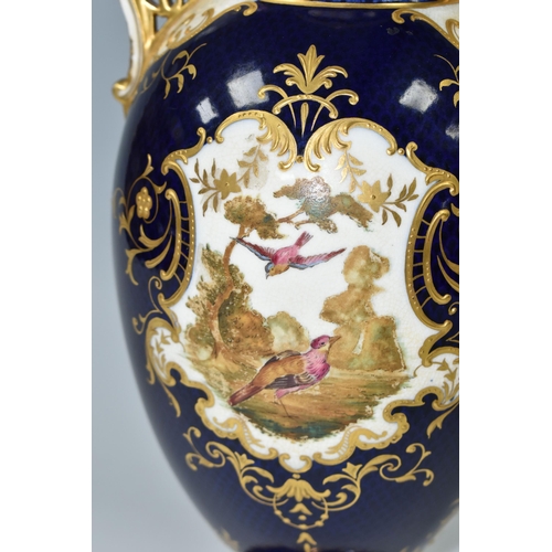 367 - A COALPORT COVERED PEDESTAL VASE, with pierced twin handles, a cobalt blue patterned ground with rai... 